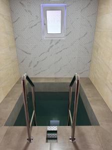 a swimming pool with a window in a building at Вича in Sasivka