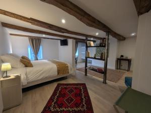 a bedroom with a bed and a living room at La demeure Langroise in Langres