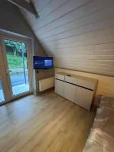 a room with a tv and a bed in a room at Вича in Sasivka