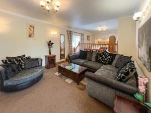 a living room with two couches and a table at Uk47549 - Carty Cottage in Newton Stewart