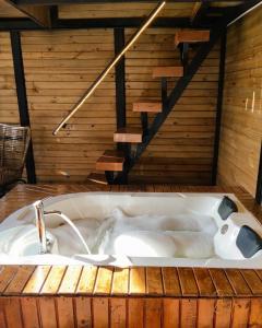 a bath tub with a sink in a room at OMGHAT Glamping in El Peñol