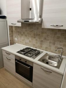 a kitchen with a stove and a sink at Domus Cesare in Rome