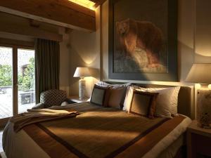 a bedroom with a large bed with a picture of a bear at LeCrans in Crans-Montana