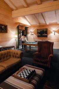 a man playing a game of pool in a room at LeCrans in Crans-Montana