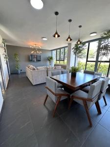 a large living room with a wooden table and chairs at AR Suites 2 La Calzada in Zamora de Hidalgo