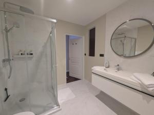 a bathroom with a shower and a sink and a mirror at La demeure Langroise in Langres +21 photos