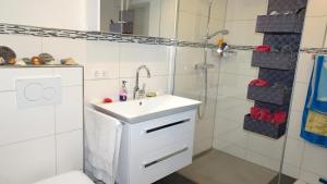 a white bathroom with a sink and a shower at Marienhof in Leibertingen +20 photos
