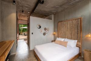 a bedroom with a white bed in a room at The Penthouse Perch in Jacó +62 photos