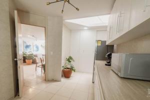 a kitchen with a door open to a dining room at AR Suites Casa Master Suite Nueva Luneta in Zamora de Hidalgo