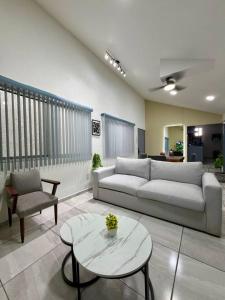 a living room with a couch and a table at AR Suites 1 Centro de la ciudad in Zamora de Hidalgo