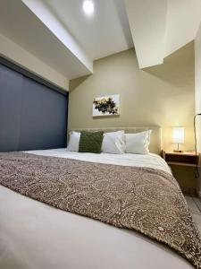 a bedroom with a large bed with a large bedspread at AR Suites 1 Centro de la ciudad in Zamora de Hidalgo