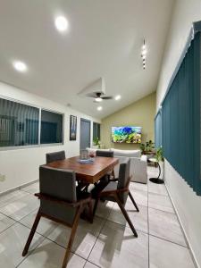 a dining room with a wooden table and chairs at AR Suites 1 Centro de la ciudad in Zamora de Hidalgo +45 photos