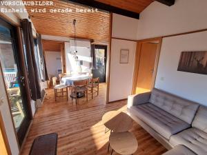 a living room with a couch and a table at Wald Chalet Nr 4 in Kellenhusen