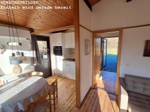 a room with a bed and a table in a room at Wald Chalet Nr 4 in Kellenhusen