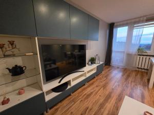 a living room with a large flat screen tv at Apartament KARO in Zawiercie