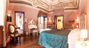 a bedroom with a bed and a desk in it at B&B Il Glicine Molare in Cremolino