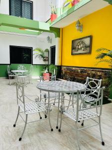 a table and chairs in a room with a yellow wall at Hotel Valladolid in Valladolid