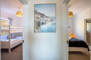 a bedroom with a bed and a painting on the wall at Stunning Water Views 2 in Jindabyne