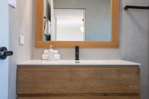 a bathroom with a sink and a mirror at Stunning Water Views 3 in Jindabyne +17 photos
