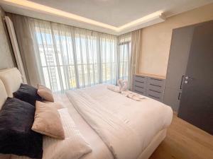 a bedroom with a large bed with a large window at Eurovea Tower Apartment 27th floor, Luxury bed VISPRING Baronet Superb in Ovsište