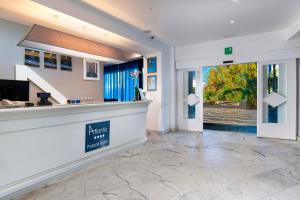 a large lobby with a reception counter and a door at Atlantic Palace Hotel in Sorrento +89 photos