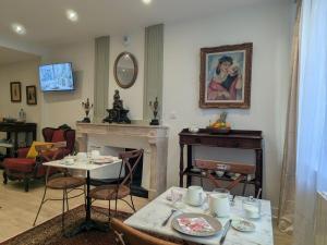 a living room with a table and a fireplace at La demeure Langroise in Langres