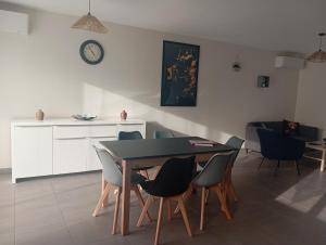 a kitchen and dining room with a table and chairs at Loire et Vignes in Saint-Bouize
