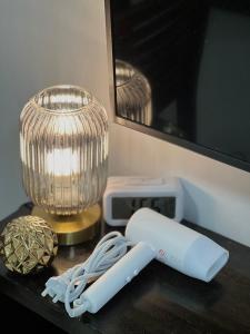 a remote control sitting on a table next to a vase at La Montañosa at Brenthill Baguio Condo near City Center in Baguio