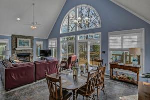 a living room with a table and a couch at Lakefront Retreat-Sunset Views in Prosperity