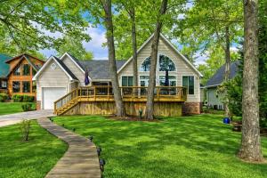 a large house with a large deck and trees at Lakefront Retreat-Sunset Views in Prosperity