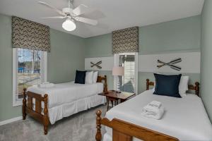 a bedroom with two beds and a ceiling fan at Lakefront Retreat-Sunset Views in Prosperity