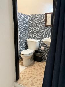 a bathroom with a toilet and a sink at Hotel Valladolid in Valladolid +19 photos
