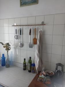 a kitchen counter with utensils on a tiled wall at apartamento céntrico zona Marques de comillas 8 in Laredo