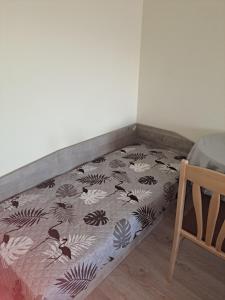 a bed in the corner of a room at Удобство - 3 in Petrich