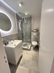a bathroom with a shower and a sink and a toilet at Mittendrin 102 in Sylt +11 photos