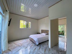 a bedroom with a bed on a marble floor at Alojamiento in Nueva Loja +25 photos