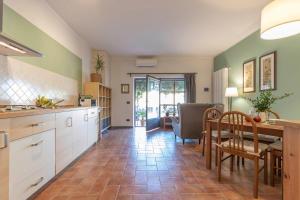 a kitchen with a table and a dining room at Ginger House in Usigliano