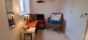 a small living room with a couch and a chair at Chez Jo in Lewes +3 photos