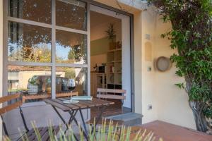 a patio with a table and a glass door at Ginger House in Usigliano