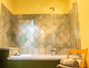 a bathroom with a shower and a bath tub at B&B Il Glicine Molare in Cremolino