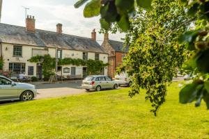 a group of cars parked in front of a building at Wallower in Harpley
