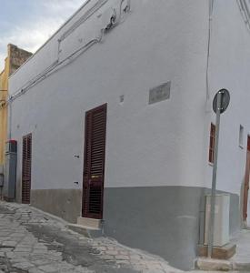 a white building with a door on the side of it at Antica dimora LUNA in Casarano