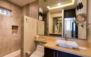 a bathroom with a sink and a toilet and a mirror at Suites at Zona Romantica in Puerto Vallarta +32 photos