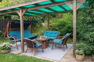 a patio with chairs and a table and a pergola at Apartma Xanadu in Slovenske Konjice