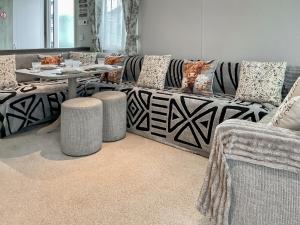 a living room with a couch and a table at 54 Beach Retreat in Burnham on Sea
