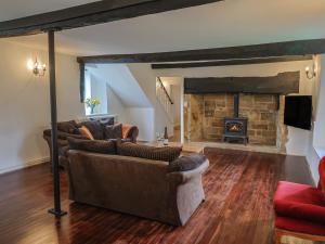 a living room with two couches and a fireplace at Manor Cottage in Ilminster