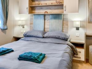 a bed with two towels sitting on top of it at 54 Beach Retreat in Burnham on Sea