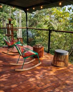 two colorful chairs sitting on a wooden deck at OMGHAT Glamping in El Peñol +61 photos