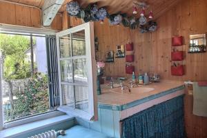 a bathroom with a sink and a window at Rue des dolmens in Saint-Quay-Portrieux