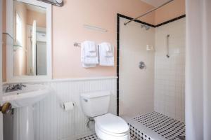 a bathroom with a toilet and a sink and a shower at Curry Mansion Inn in Key West +73 photos